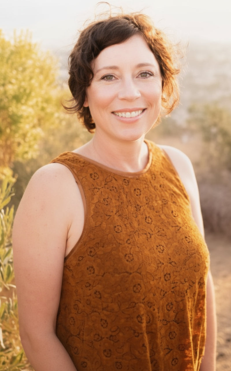 Woman wearing a brown knitted sleeveless sweater outdoors